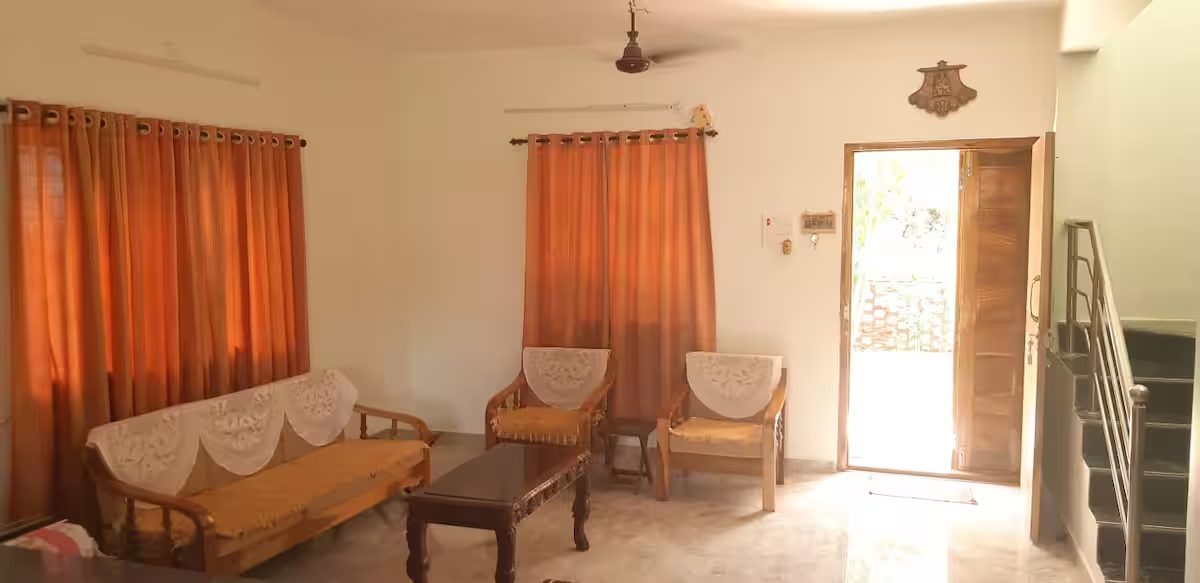 Living room with staircase and front entrance